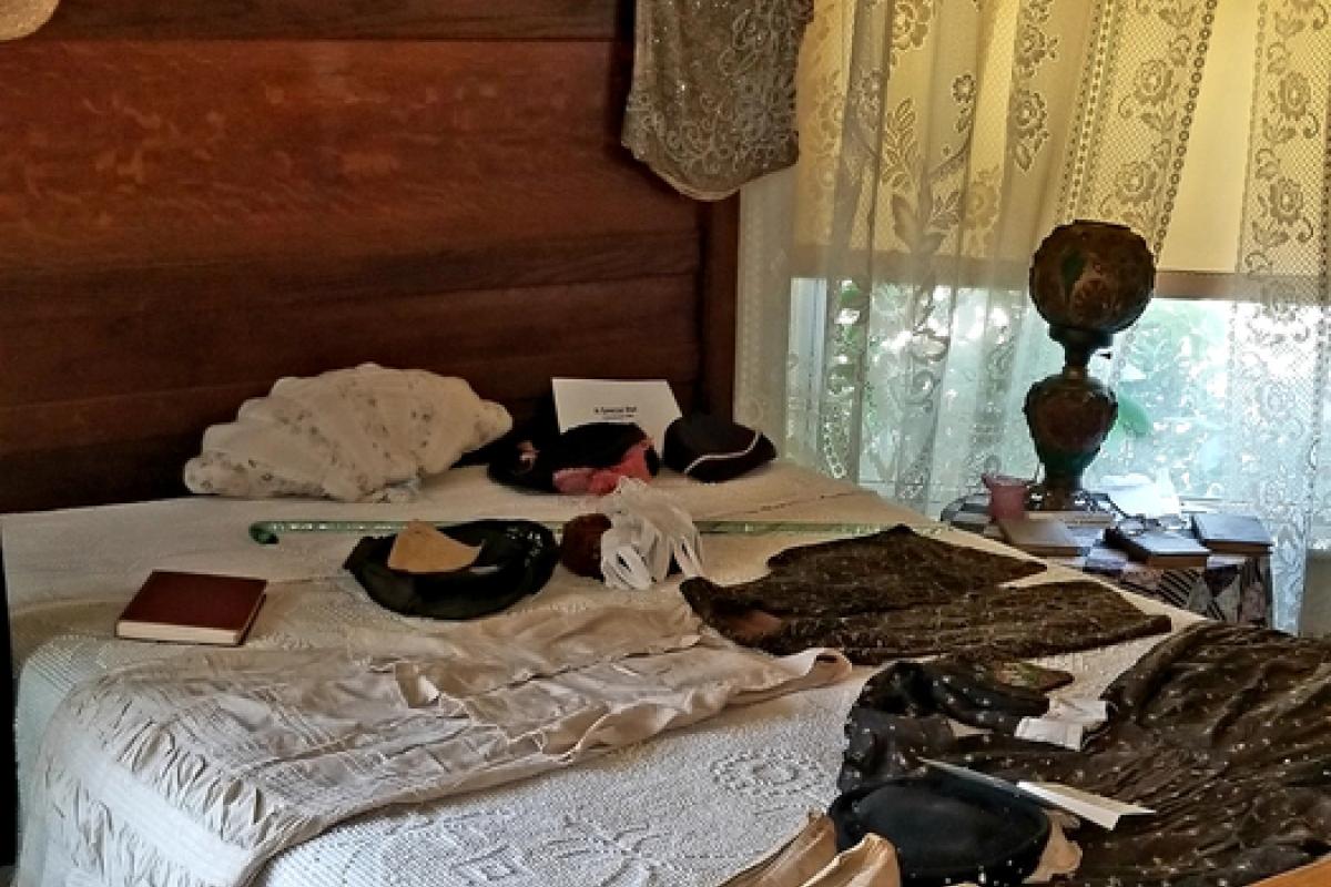 Antique bed with clothing laid out