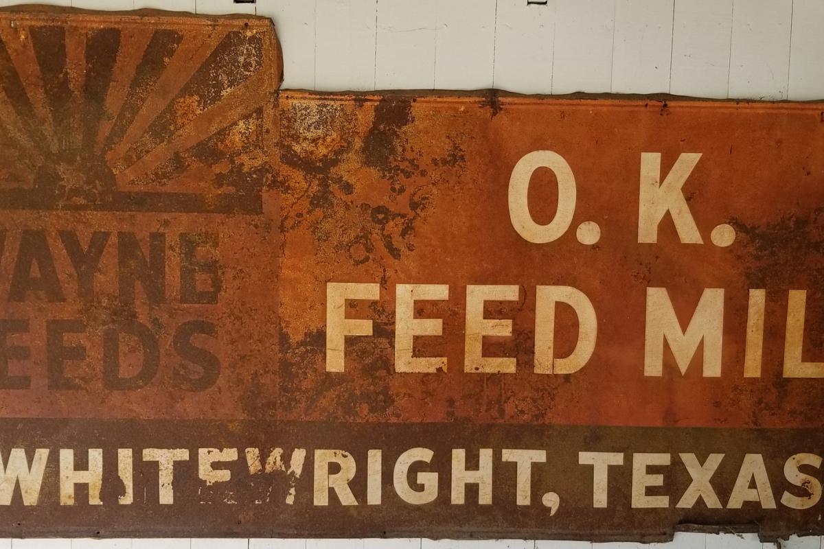 Rusted sign for O.K. Feed Mill, Whitewright, Texas