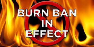 Image of flames with text burn ban in effect
