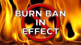 "Burn Ban in Effect" on flames background