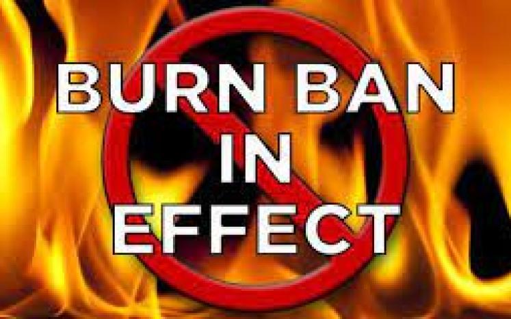 Image of flames with text burn ban in effect